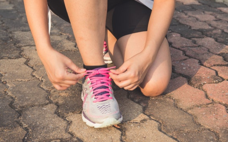 person tying shoelace